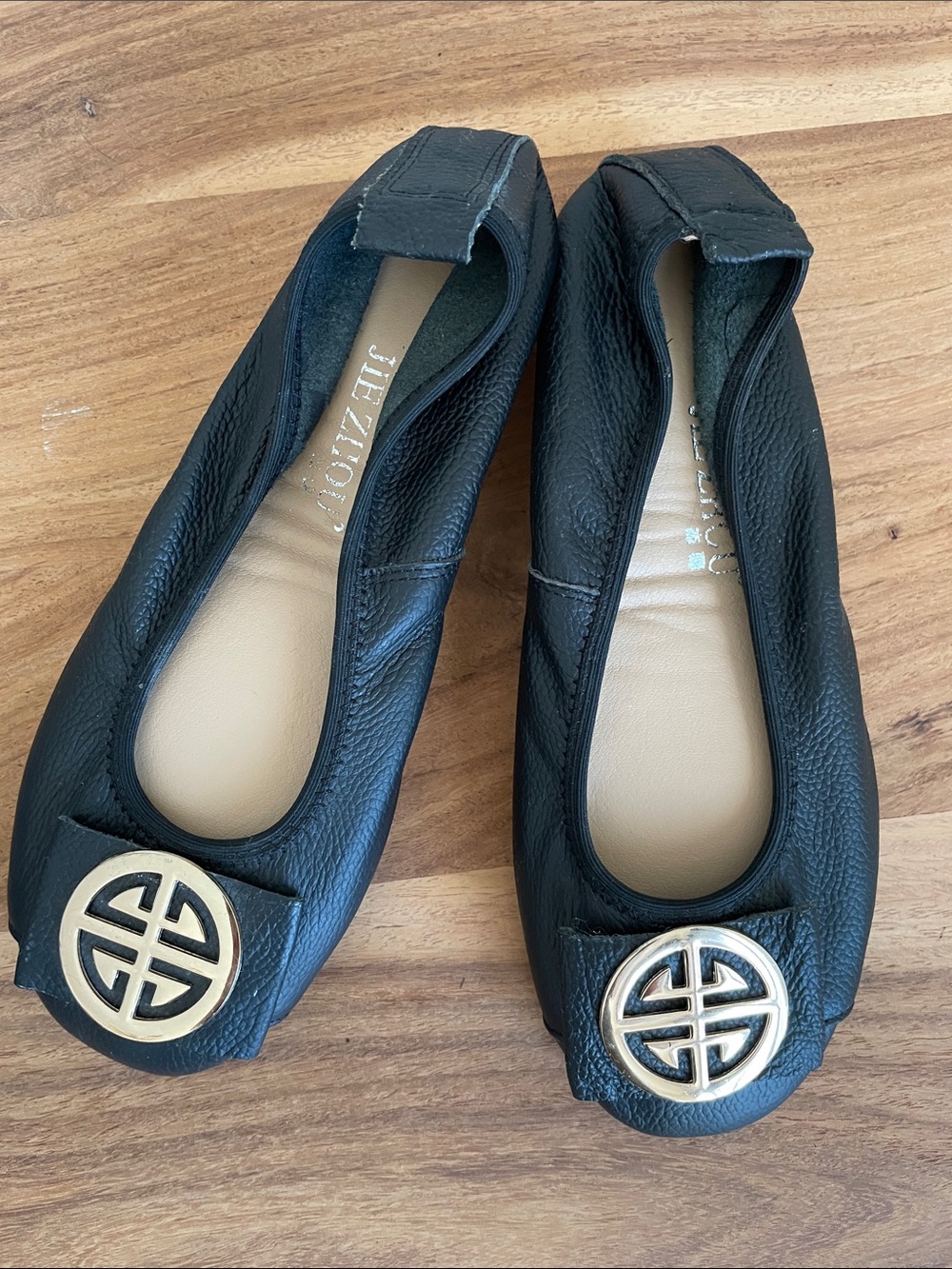 7.   Black Leather Ballet Flats with Gold Emblem